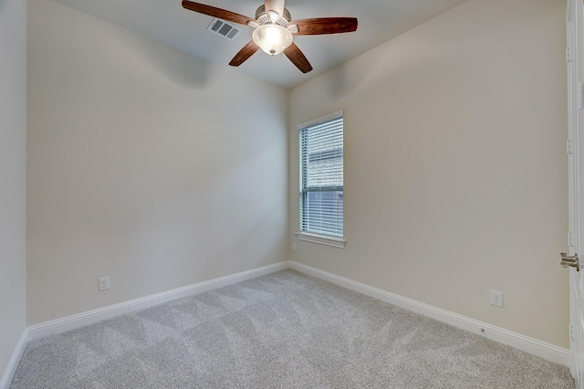 carpeted spare room featuring ceiling fan