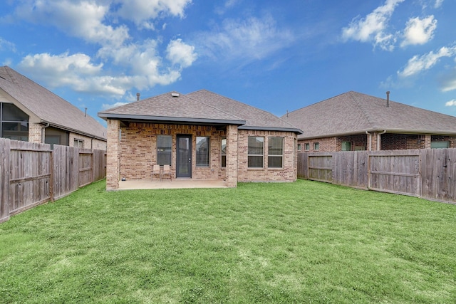 back of house featuring a yard and a patio