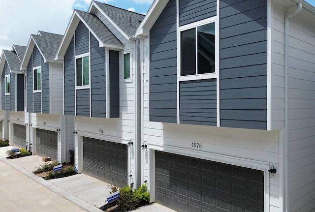 view of side of home featuring a garage