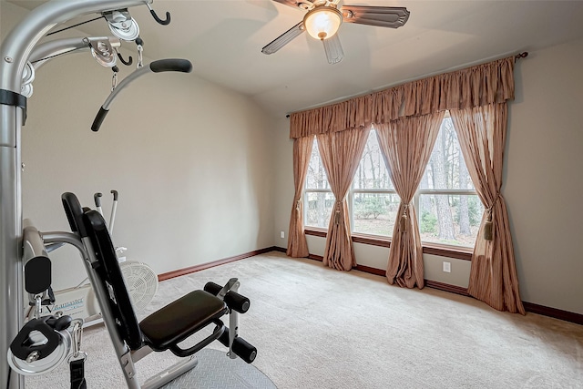 exercise room with ceiling fan, lofted ceiling, and light carpet