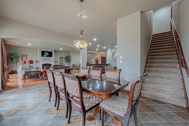 12403 Summer Lake Ranch Dr, Houston, TX 77044 - dining area with visible vents, stairway, recessed lighting, and a fireplace