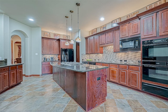 12403 Summer Lake Ranch Dr, Houston, TX 77044 - kitchen featuring tasteful backsplash, a warming drawer, a center island, black appliances, and dark stone counters