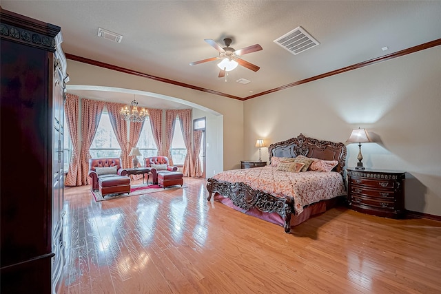 bedroom featuring crown molding, ceiling fan with notable chandelier, and light hardwood / wood-style flooring