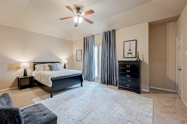 carpeted bedroom with vaulted ceiling and ceiling fan