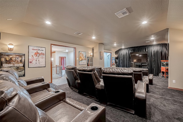 carpeted home theater room featuring vaulted ceiling and a textured ceiling