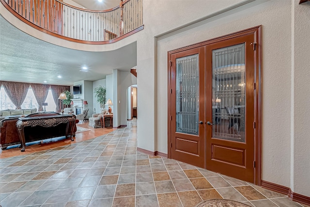 12403 Summer Lake Ranch Dr, Houston, TX 77044 - tiled entrance foyer with french doors, arched walkways, and baseboards