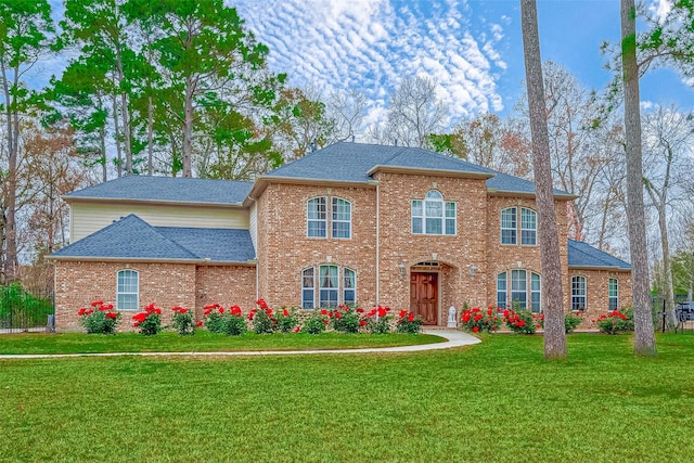 12403 Summer Lake Ranch Dr, Houston, TX 77044 - view of front of home with brick siding, a shingled roof, and a front lawn