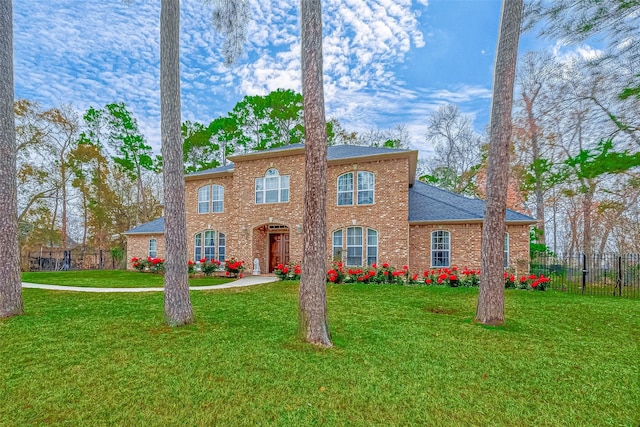 12403 Summer Lake Ranch Dr, Houston, TX 77044 - view of front of home featuring brick siding, fence, roof with shingles, and a front yard