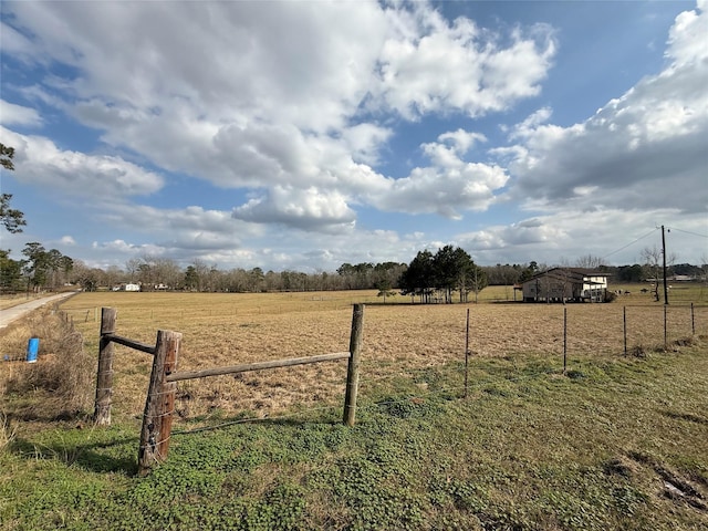 view of yard with a rural view