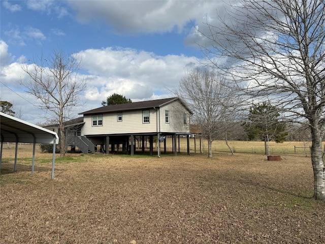 back of house featuring a carport