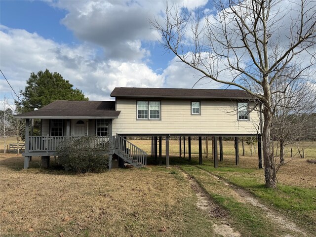 back of house with a porch and a lawn