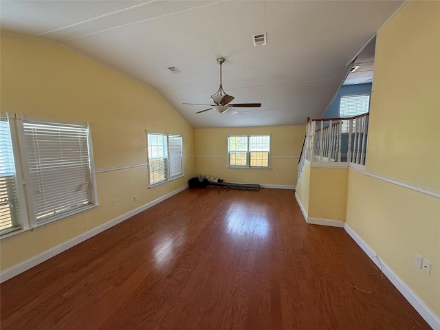 empty room featuring hardwood / wood-style flooring, vaulted ceiling, and ceiling fan