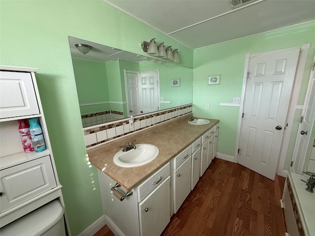 bathroom with tasteful backsplash, wood-type flooring, vanity, and toilet