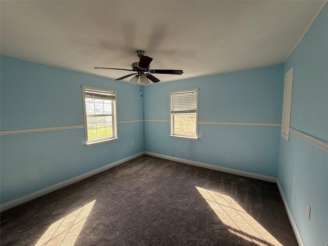 unfurnished room with ceiling fan and carpet