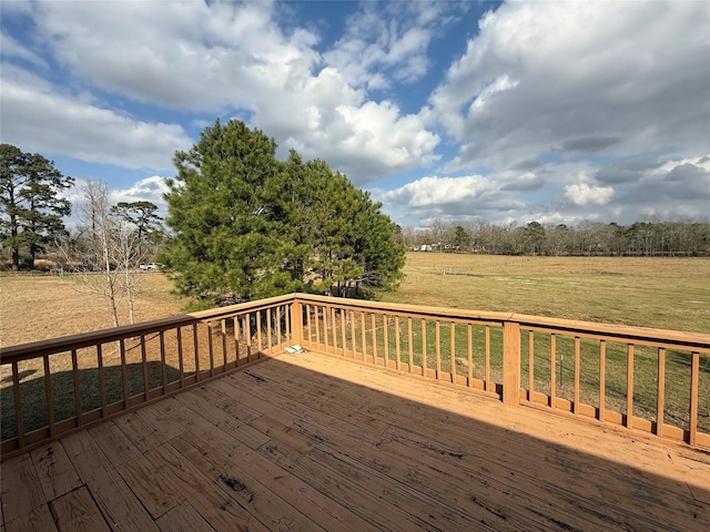 deck with a yard and a rural view