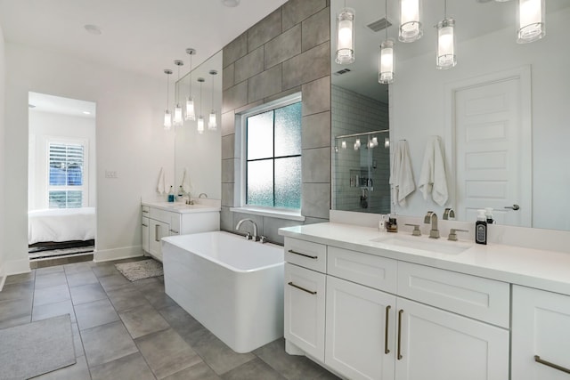 bathroom with vanity, tile patterned flooring, plus walk in shower, and a healthy amount of sunlight