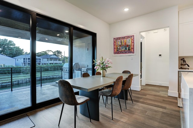 dining space with wood-type flooring