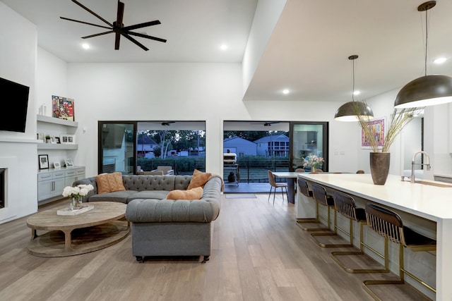 living room with sink and light wood-type flooring