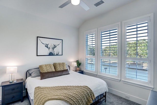 carpeted bedroom with ceiling fan and lofted ceiling