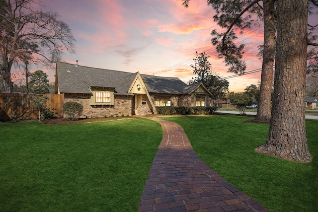 tudor house featuring a lawn