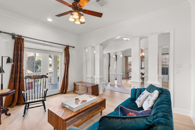 living room with crown molding, ceiling fan, decorative columns, french doors, and light wood-type flooring