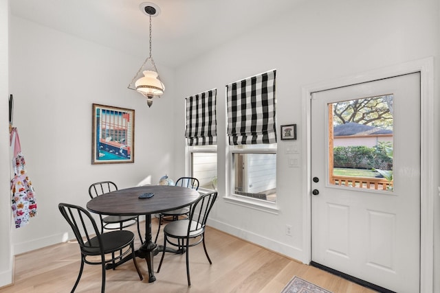 dining space with light hardwood / wood-style flooring