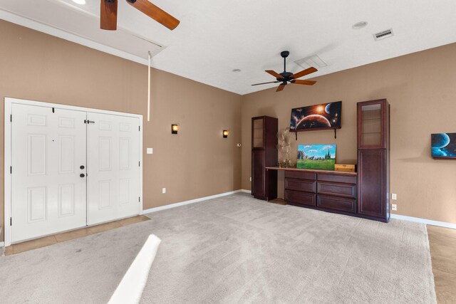 unfurnished living room featuring lofted ceiling, light colored carpet, and ceiling fan