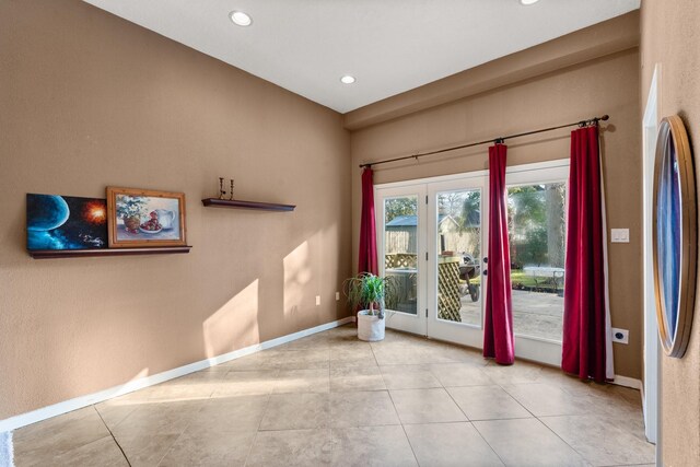 doorway with light tile patterned floors