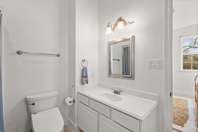 bathroom featuring vanity and toilet