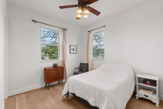 bedroom featuring light hardwood / wood-style floors and ceiling fan