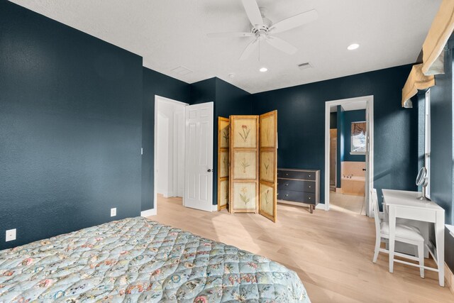 bedroom featuring ceiling fan, connected bathroom, and light wood-type flooring