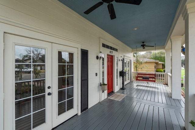 wooden deck with french doors, ceiling fan, and covered porch