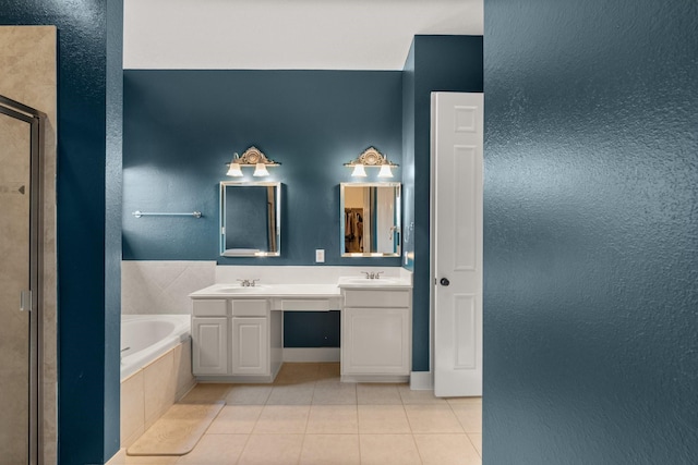 bathroom with tile patterned floors, plus walk in shower, and vanity