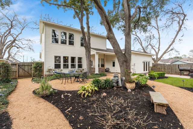 back of property with a patio