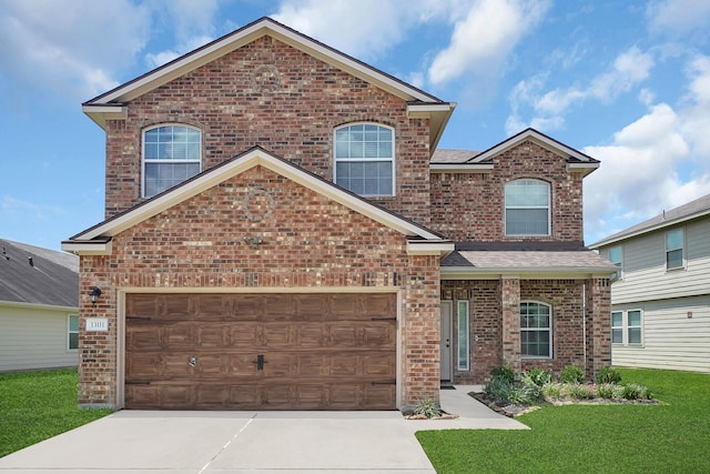 view of front of property featuring a garage and a front lawn