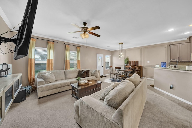 carpeted living room featuring crown molding and ceiling fan