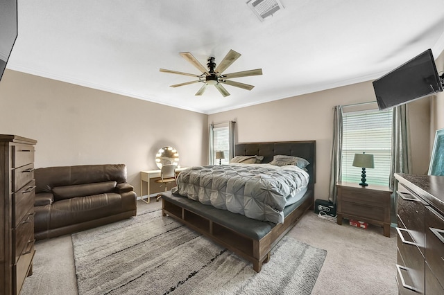 bedroom with ceiling fan, light colored carpet, and ornamental molding