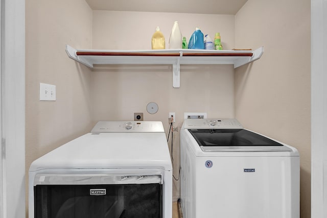 clothes washing area with separate washer and dryer