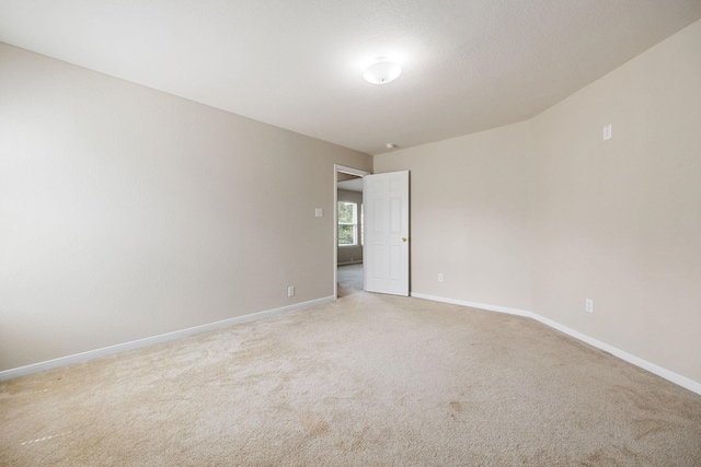 unfurnished room with light colored carpet