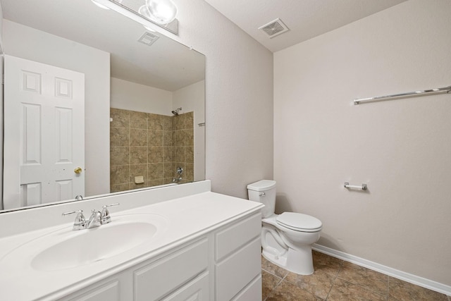 bathroom with vanity, a shower, and toilet