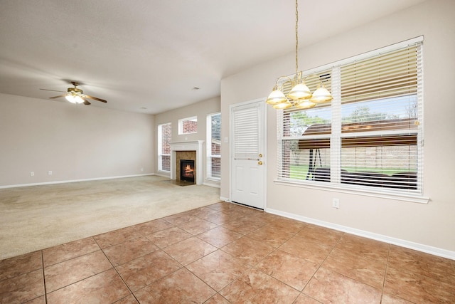 interior space with ceiling fan and carpet