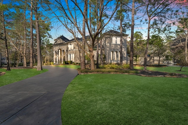 mediterranean / spanish-style home featuring a front lawn