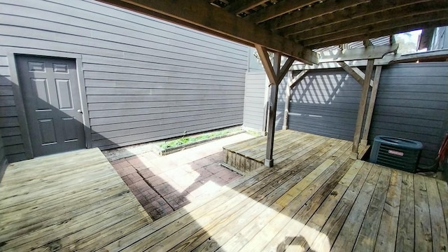 wooden deck with a pergola and central AC unit