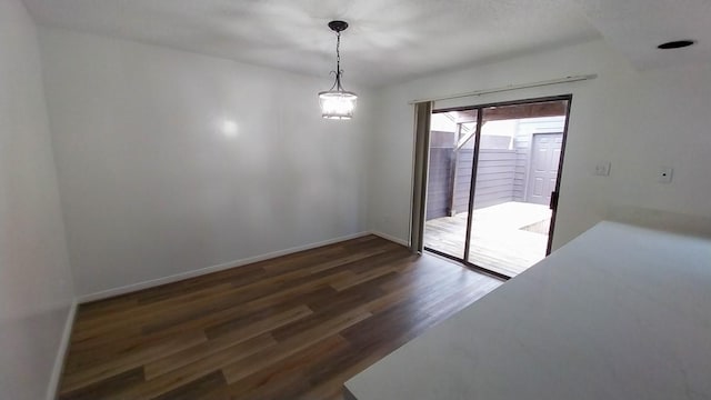 unfurnished dining area with dark hardwood / wood-style floors