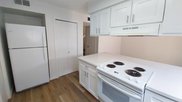 kitchen featuring white appliances, dark wood-type flooring, and white cabinets