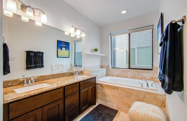 bathroom with vanity, tiled tub, and tile patterned floors