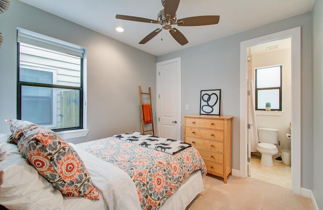 carpeted bedroom with connected bathroom and ceiling fan