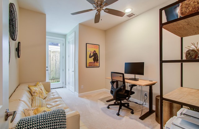 carpeted home office featuring ceiling fan