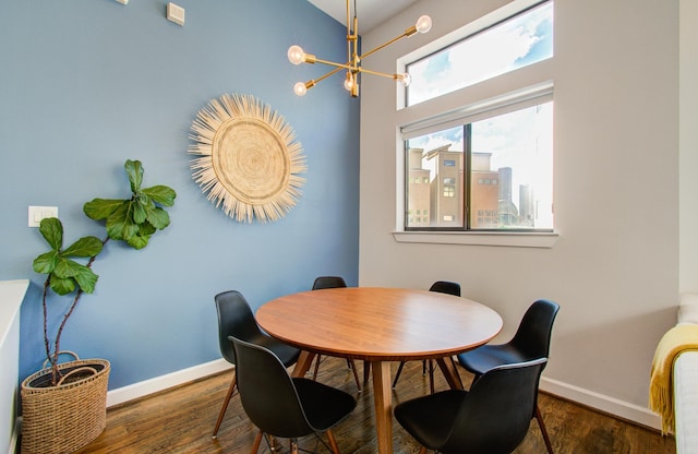 dining area featuring a notable chandelier and dark hardwood / wood-style flooring