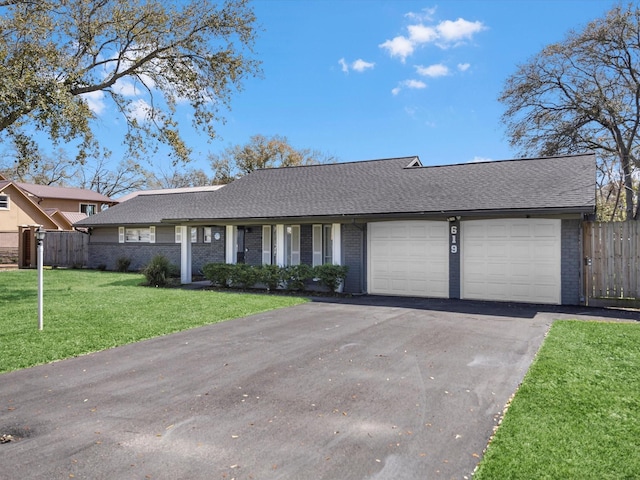 ranch-style house with an attached garage, brick siding, fence, driveway, and a front yard